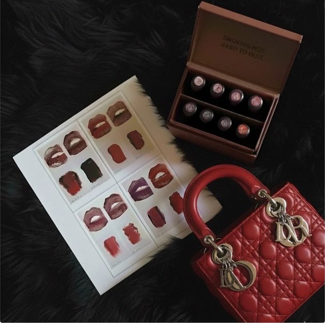Press-on nails flat-lay with a red handbag