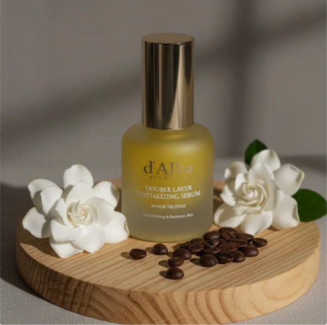 d'Alba serum flat-lay with white flowers and coffee beans